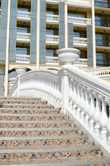 Part of the facade of luxury hotel with terrace and staircase