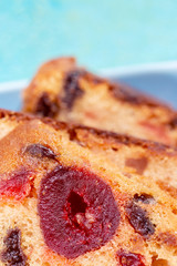 Macro image of a cake slice with fruits. Fruit cake with raisin and grapes. Close-up of sweet muffins with berry. Soft focus. Blurry background. Copy space.