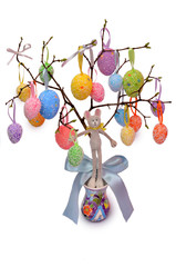 Beautiful Easter tree in a vase with colored eggs and Easter rabbit
