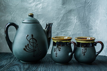 Dark tea set. Asian style. Dark wooden background.