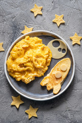 Kids funny breakfast with scrambled eggs, cheese and tortilla rocket