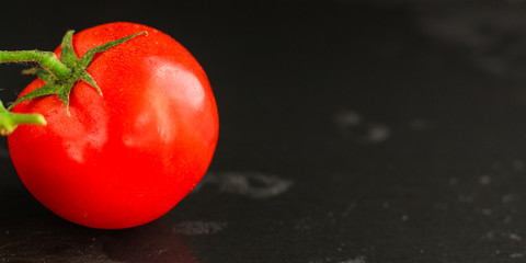 tomato on the green branch (red, ripe vegetable). food background. top view