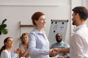 Happy female employee intern handshake helpful boss get rewarded promoted