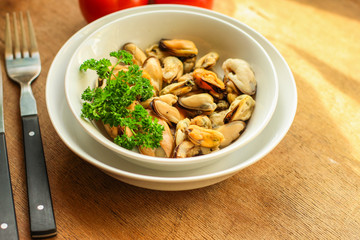 mussels A serving of seafood is a white plate. food background. top image