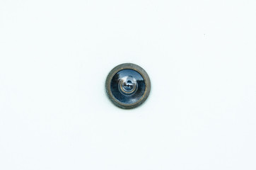 Closeup of peek hole on white door