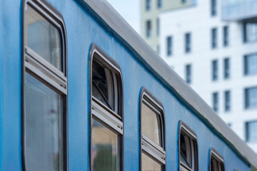 Old blue railway wagon with opened windows.