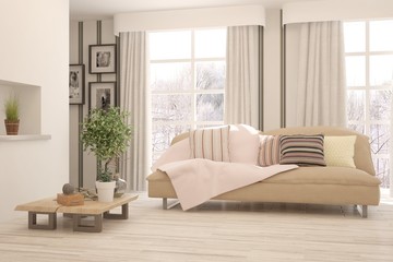 Fototapeta premium Stylish room in white color with sofa and winter landscape in window. Scandinavian interior design. 3D illustration