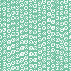 Fototapeta na wymiar Seamless pattern with decorative dotss on green background
