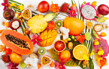 Still life with fresh assorted exotic fruits on a palm leaf.