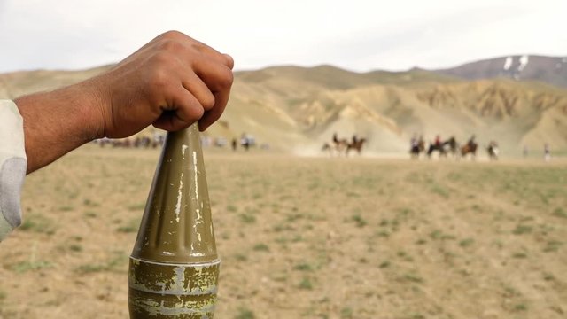 Horse mounted games played in Afghanistan are Buzkhazi, kokpar, kupkari and ulak tartysh. Over the shoulder.