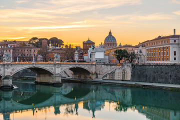 Rome, Italy. Vatican dome of Saint Peter Basilica or San Pietro and Sant'Angelo Bridge over Tiber river