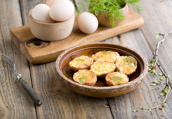 Stuffed eggs in shell fried in a pan.