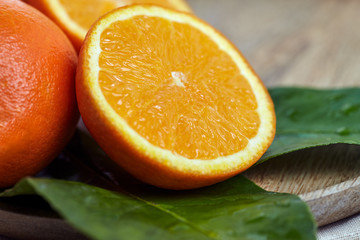 Oranges with leaves in a wooden bowl