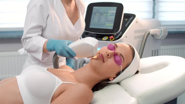 Performing of laser treatment procedure in cosmetology salon