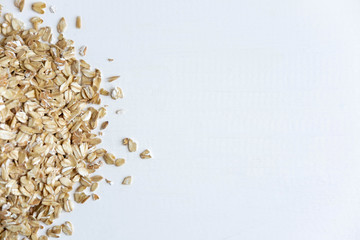 Fototapeta na wymiar Frame for a banner with oatmeal raw flakes. Oatmeal and healthy food. Diet and vitamins in oatmeal