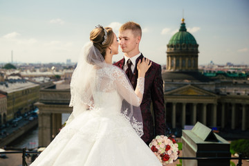 Bride and Groom on Wedding Day in city on roof in St. Petersburg.