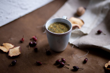 The cup of tea with flowers on wooden table
