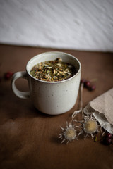 The cup of tea with flowers on wooden table