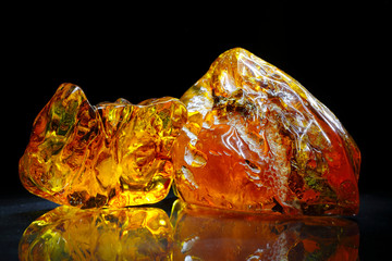 Amber. Beautiful colored pieces of amber. Amber texture. Red-yellow amber with bubbles, waves, divorces and color transitions. Natural mineral Sunstone. Material for jewelers. Crystal