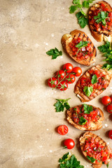 Toasts with cherry tomatoes, red onion and olive oil.Top view with copy space.