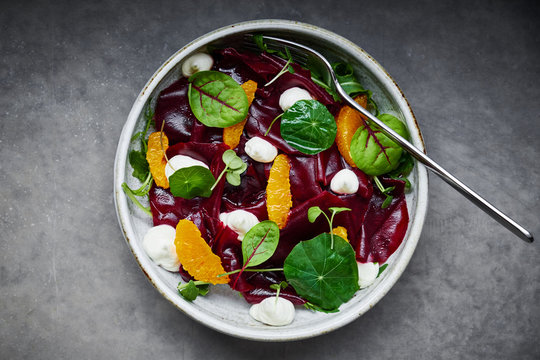 Gourmet dish with pickled beet salad and oranges served in a restaurant