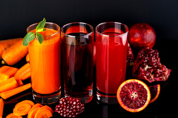 Set of healthy fresh drinks on the black background. Raw drinks and foods.