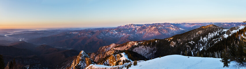 Fototapeta na wymiar Winter panorama from Cozia peak on Olt river and Builla Vnaturarita mountains