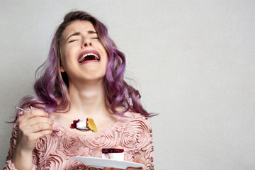 Frustrated young woman eating palatable cake with berries. Space for text