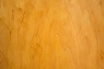 The wooden background is light brown with stripes .