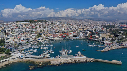 Fototapeta na wymiar Aerial drone bird's eye view panoramic photo of iconic round shaped picturesque port of Mikrolimano with sail boats and yachts docked and beautiful clouds, Piraeus port, Attica, Greece