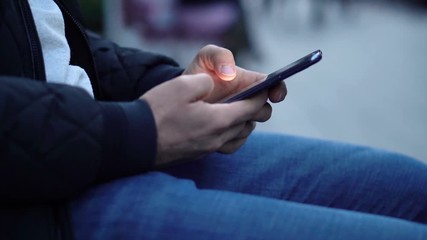 Close-up View of Man Using Smartphone in the city street