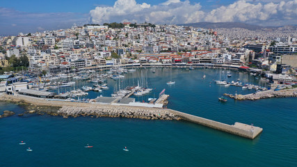 Fototapeta na wymiar Aerial drone bird's eye view panoramic photo of iconic round shaped picturesque port of Mikrolimano with sail boats and yachts docked and beautiful clouds, Piraeus port, Attica, Greece