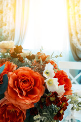 colorful bouquet of artificial flowers made of fabric, fake red roses, copy space