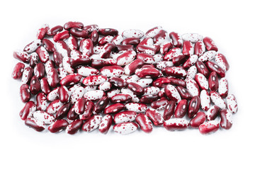 Pile of ripe speckled kidney Anasazi beans, with vivid burgundy color isolated on white background. Close-up.