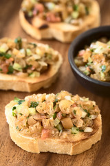Chilean Pebre Salsa made of Cochayuyo (lat. Durvillaea antarctica) or bull kelp seaweed, tomato, hot aji chili pepper, onion, garlic parsley on toasted bread (Selective Focus)