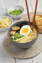 Egg noodle soup with bamboo shoots, tofu, and nori
