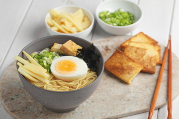 Egg noodle soup with bamboo shoots, tofu, and nori