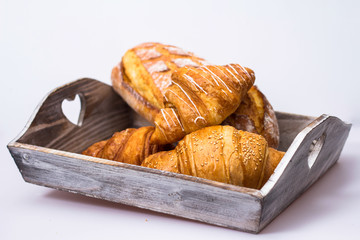 croissants in basket on wooden table