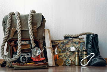 Travel or adventure background. Treasure map, backpack, boot, binoculars, compass, pocket watch,...