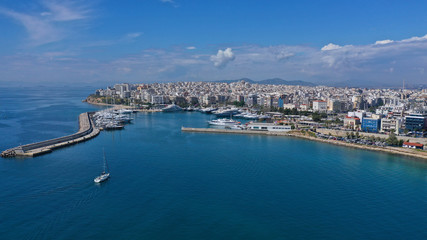 Fototapeta na wymiar Aerial drone panoramic photo of iconic port of Marina Zeas or Pasalimani with yachts and sail boats docked and beautiful blue sky - clouds, port of Piraeus, Attica, Greece