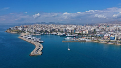 Fototapeta na wymiar Aerial drone panoramic photo of iconic port of Marina Zeas or Pasalimani with yachts and sail boats docked and beautiful blue sky - clouds, port of Piraeus, Attica, Greece