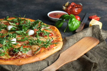 Traditional Italian pizza on a dark background.