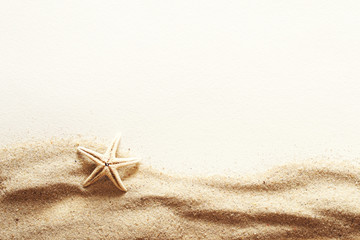 Starfish, sea sand and white background, top view, copy space. Sea summer vacation background with space for the text