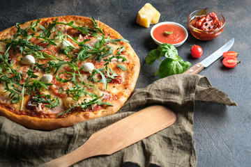 Traditional Italian pizza on a dark background.