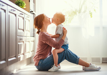 happy family mother and child son hugging