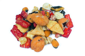 Mix of Japan snacks isolated on white background. Including tempura, nori maki, crackers in nori, close up.