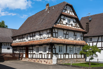 Fototapeta na wymiar Traditional half-timbered houses in the streets of the small town of Hunspach in Alsace