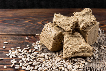 Sunflower halva on dark wooden background.