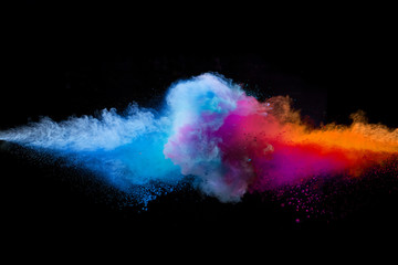 Colored powder explosion on black background.