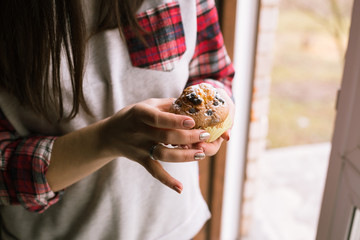 Muffin on girl hands. Close up.